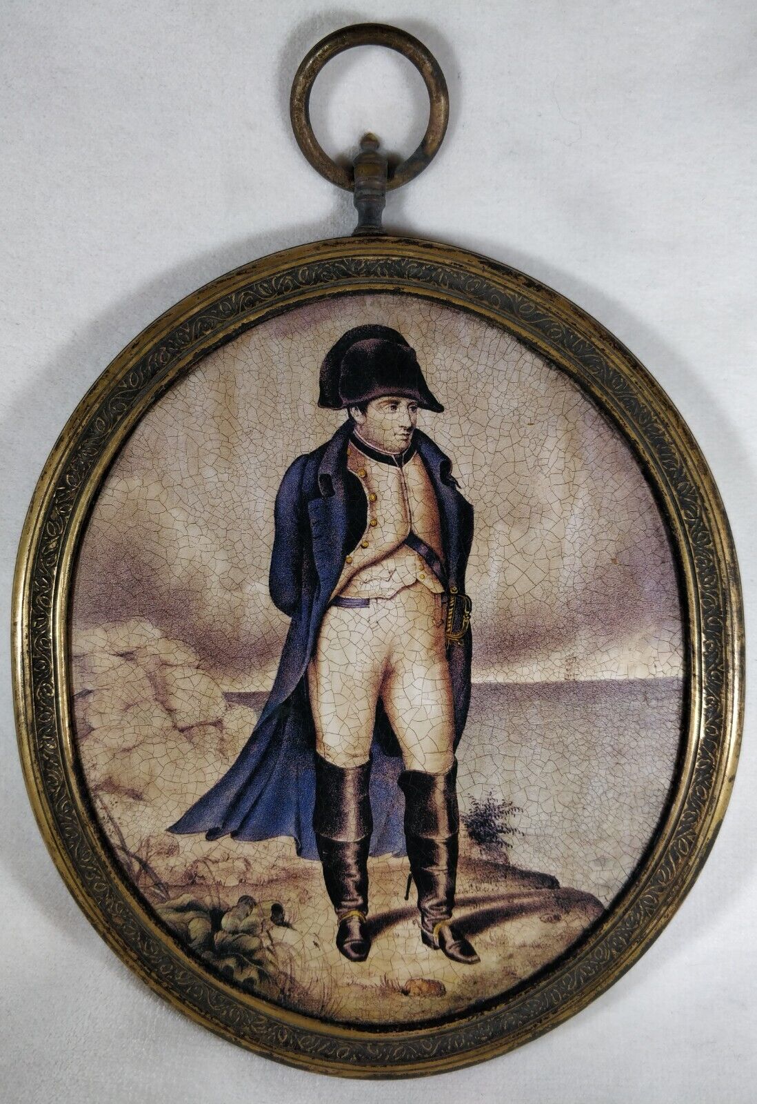 Napoleon Bonaparte portrait in a bronze frame.