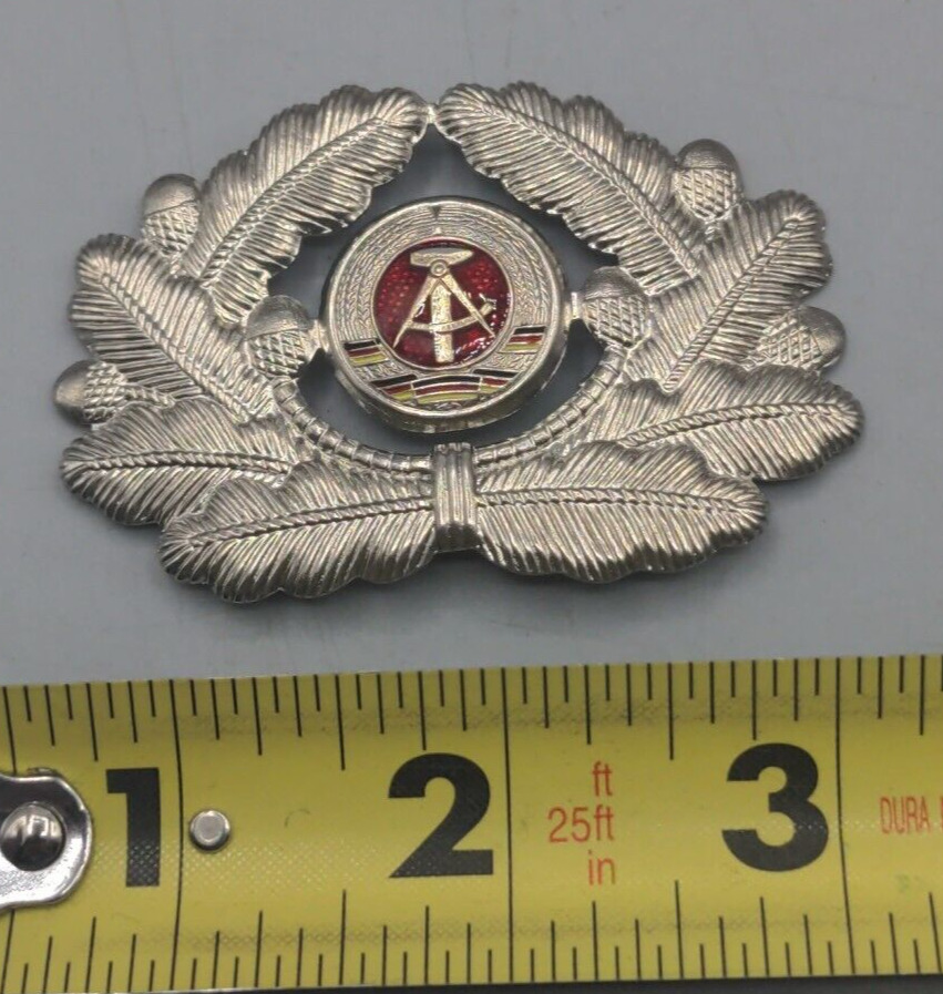 Post WWII/2 East German visor cap badge with two prongs intact.