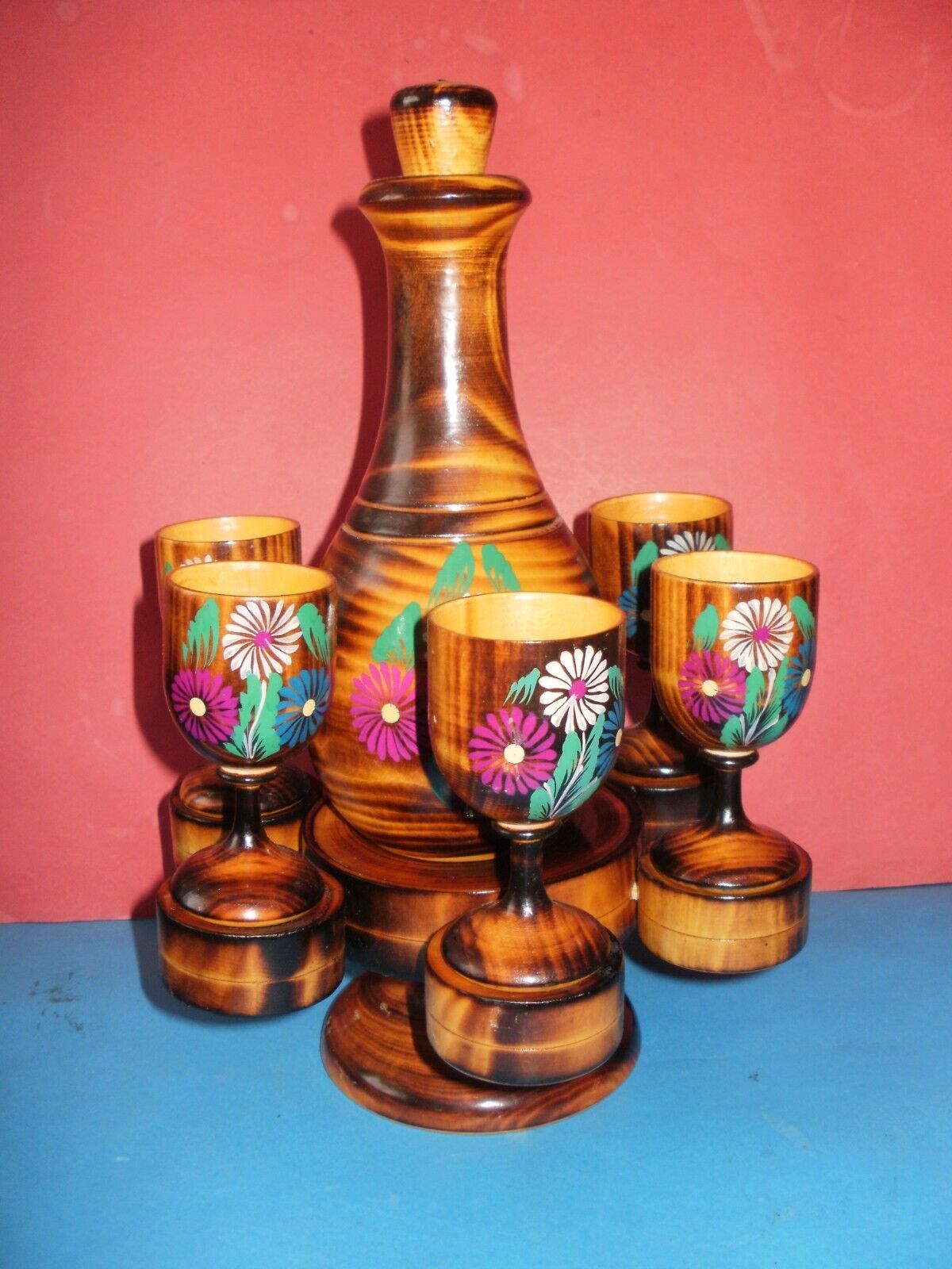 Magnificent Russian hand painted ethnic wooden drink set, a bottle and 6 glasses