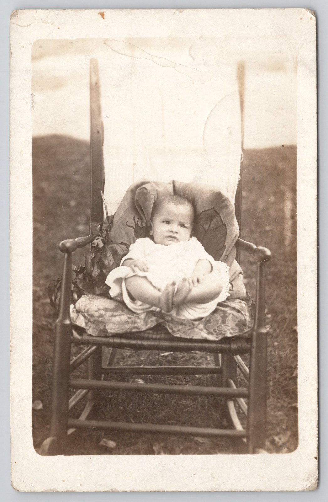RPPC Baby Sitting In Rocking Chair Playing With Feet c1910  Real Photo Postcard