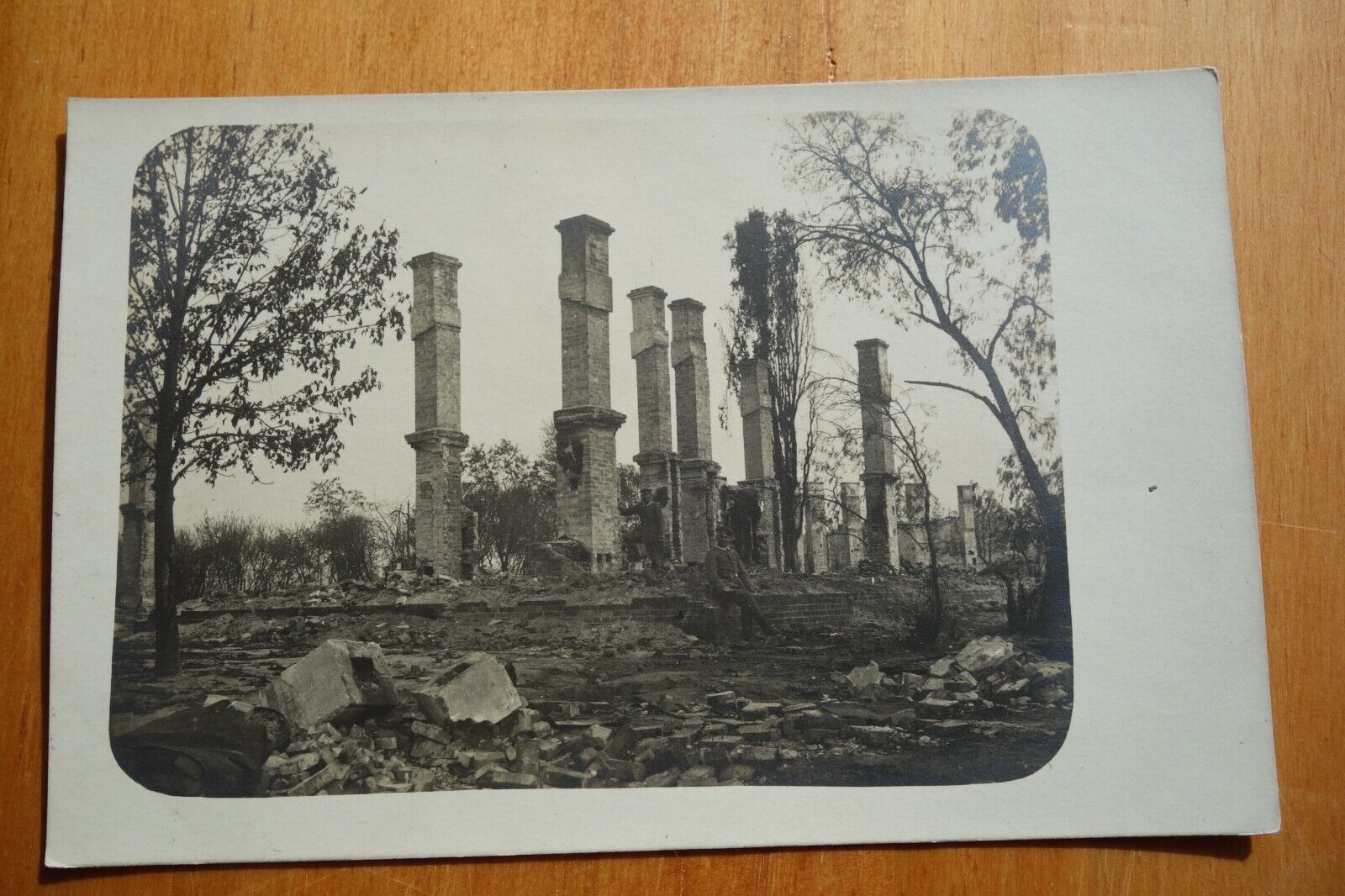 WW1 Europe men stand around the ruins real photo postcard