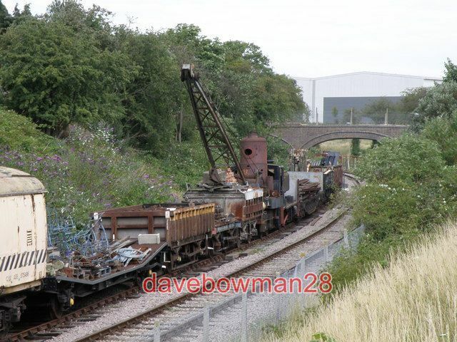 PHOTO  ROLLING STOCK ON THE LINE AT RUSHDEN A LINE OF MIXED ROLLING STOCK ON THE