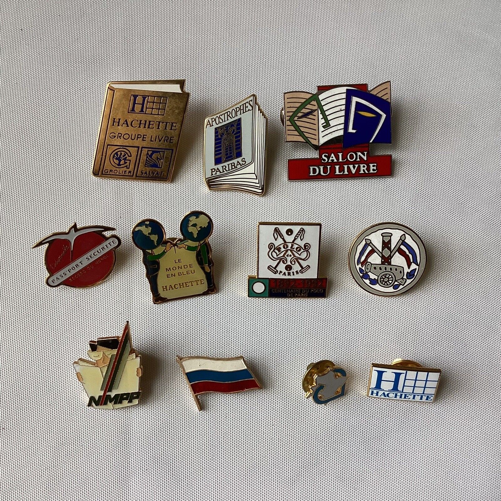 Lot Of 11 VTG French Collectible Pins: Hachette, Polo Paris, Salon De Livre, Etc