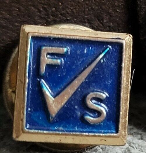 Vintage gold tone metal lapel pin with letters F S and Checkmark 