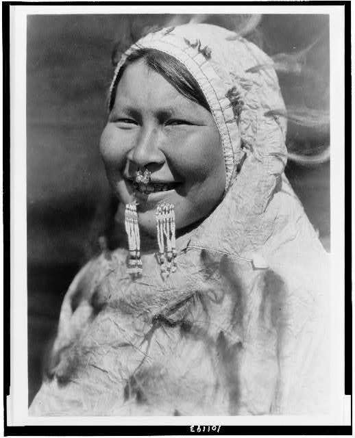 Uiyaku,Nunivak,Eskimo woman,nose ring,labret,hooded parka,Natives,E Curtis,c1929