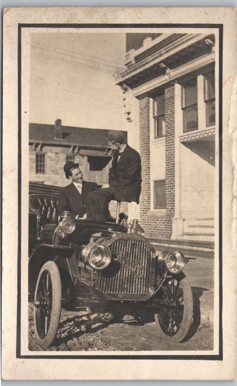 RPPC-Two men sitting on 1912 Buick Special