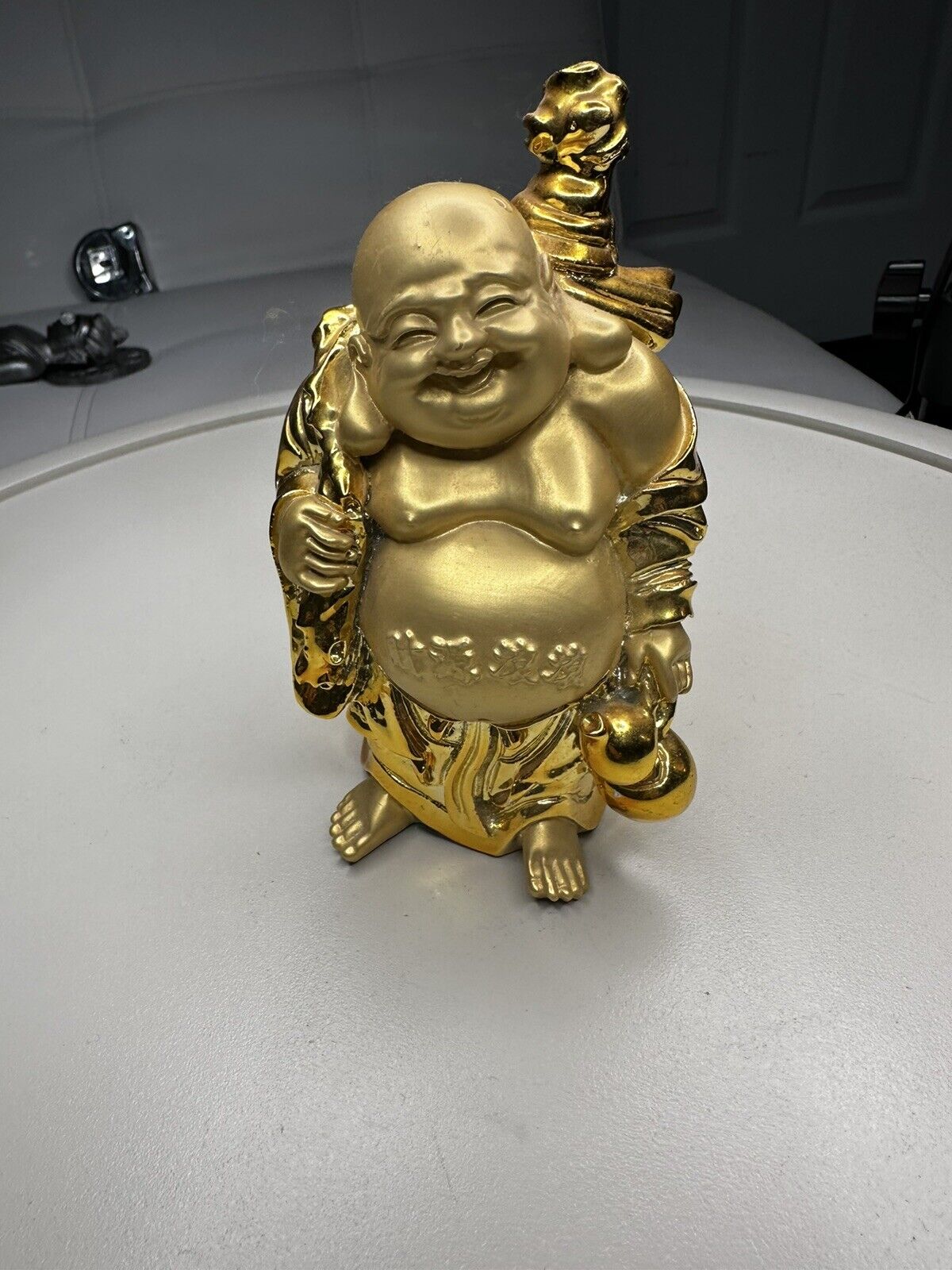 Golden Buddha Carrying A Sack