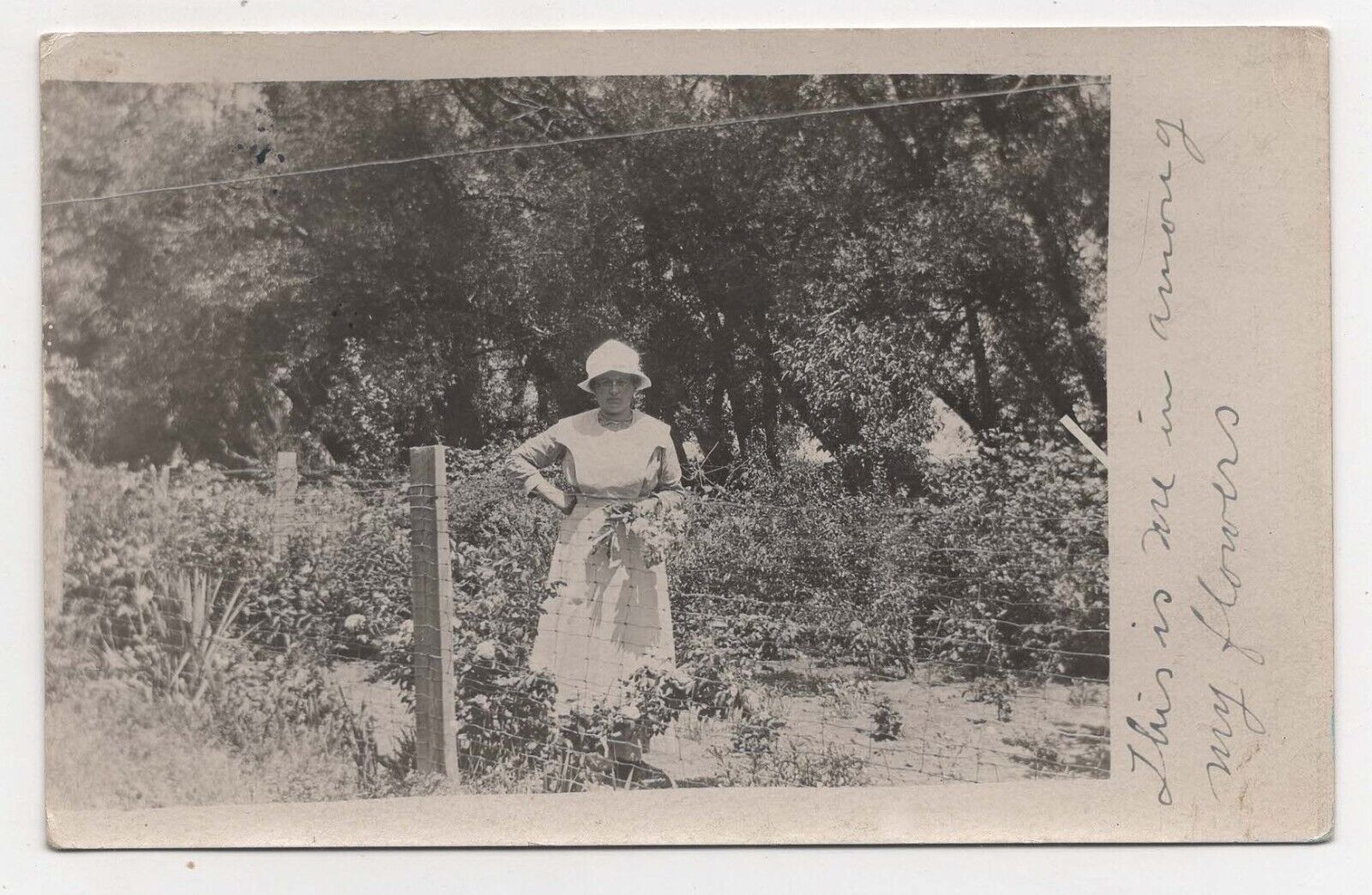 RPPC POSTCARD 1914  OLDER LADY STANDING IN GARDEN BEAMAN IOWA POSTED