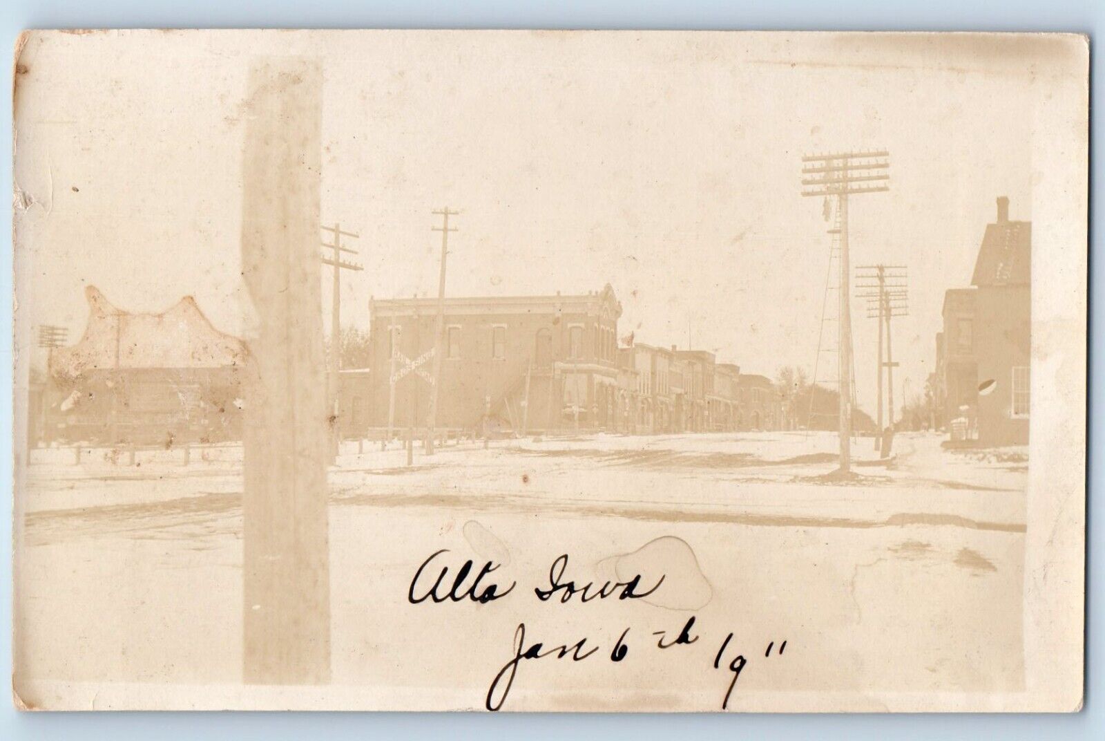 Alta Iowa IA Postcard RPPC Photo Railroad Crossing Winter Building Scene c1910's
