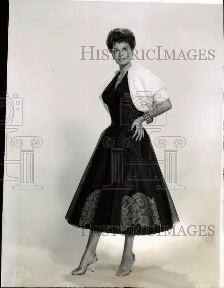 1957 Press Photo Actress Eva Bartok models black short-length evening gown in CA