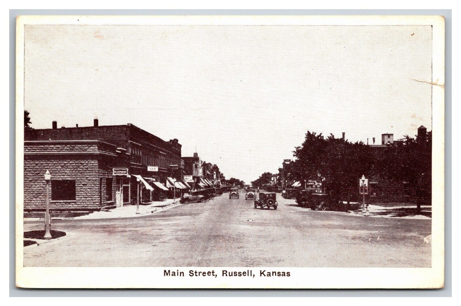 Postcard Russell KS Kansas Main Street View Black and White Old Cars Shops