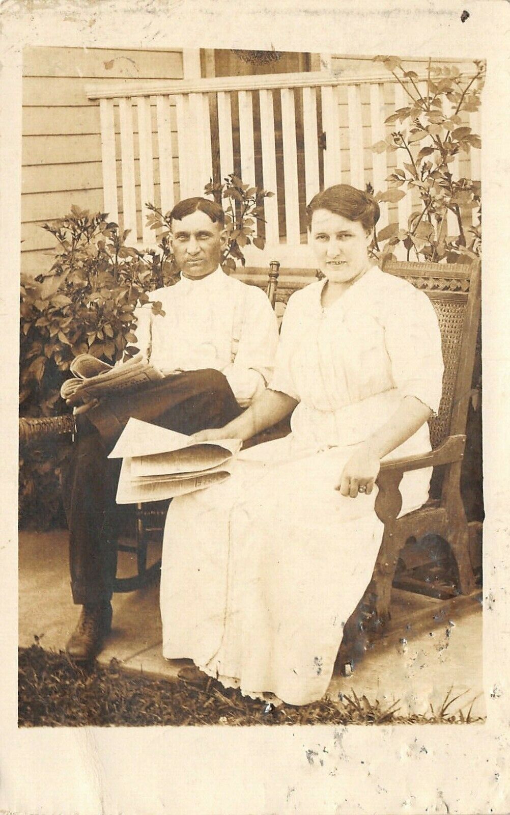 Real Photo Postcard~Carrie & Charlie Reading Newspapers by Roses~Porch~1912 RPPC