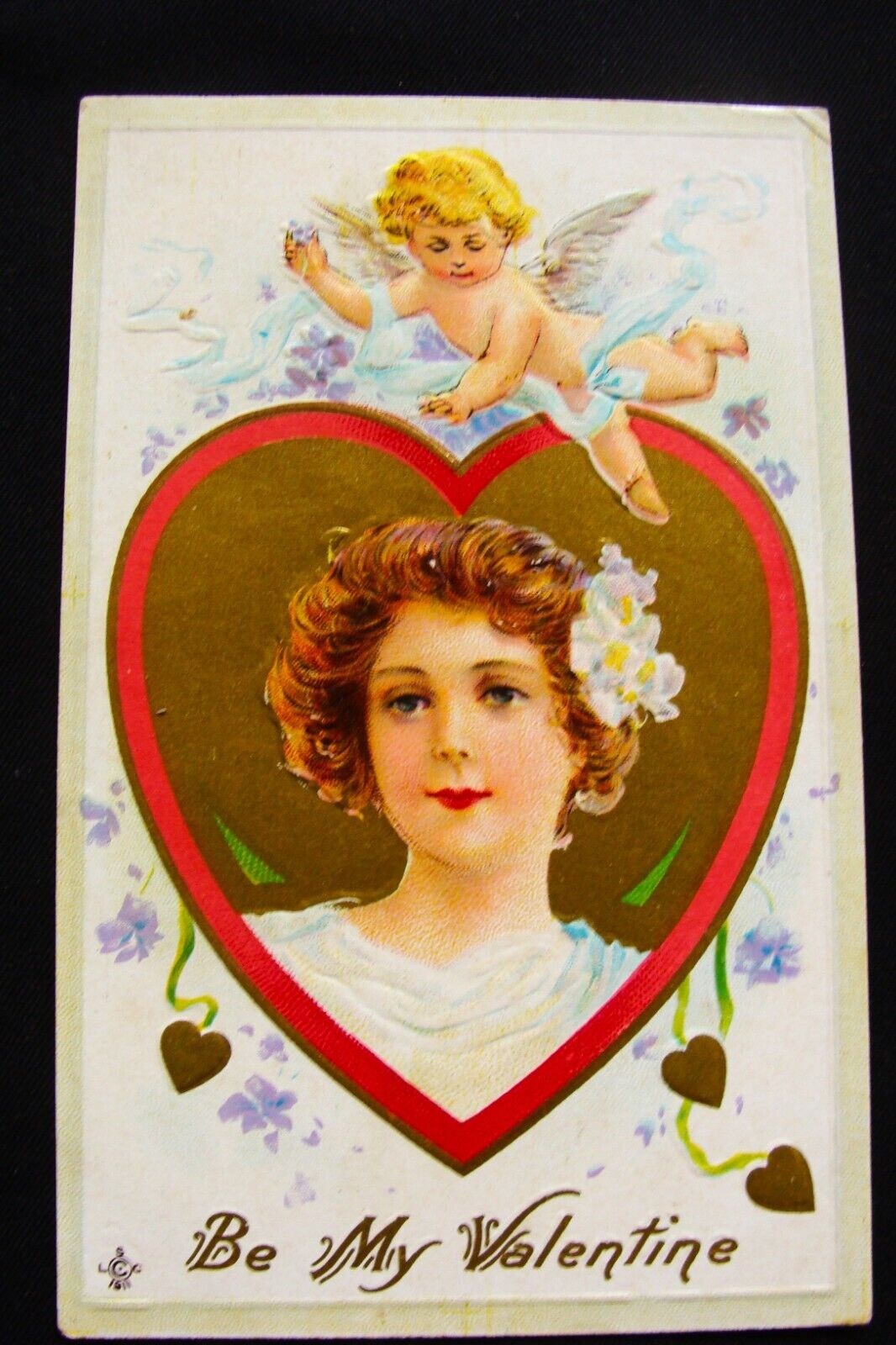 Cupid Wrapped In Blue Ribbon Over Blonde Girl in Heart Cameo Valentine Postcard