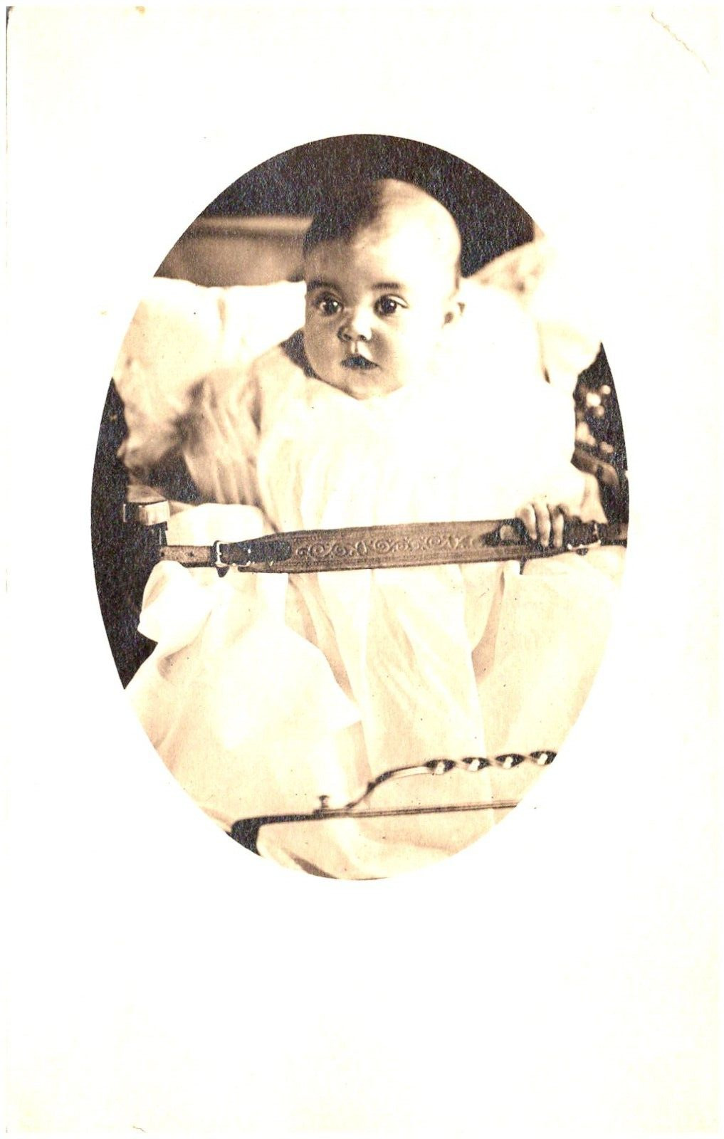 RPPC Cute Wee Baby in a Pram/Stroller, White Gown, Leather Belt Restraint