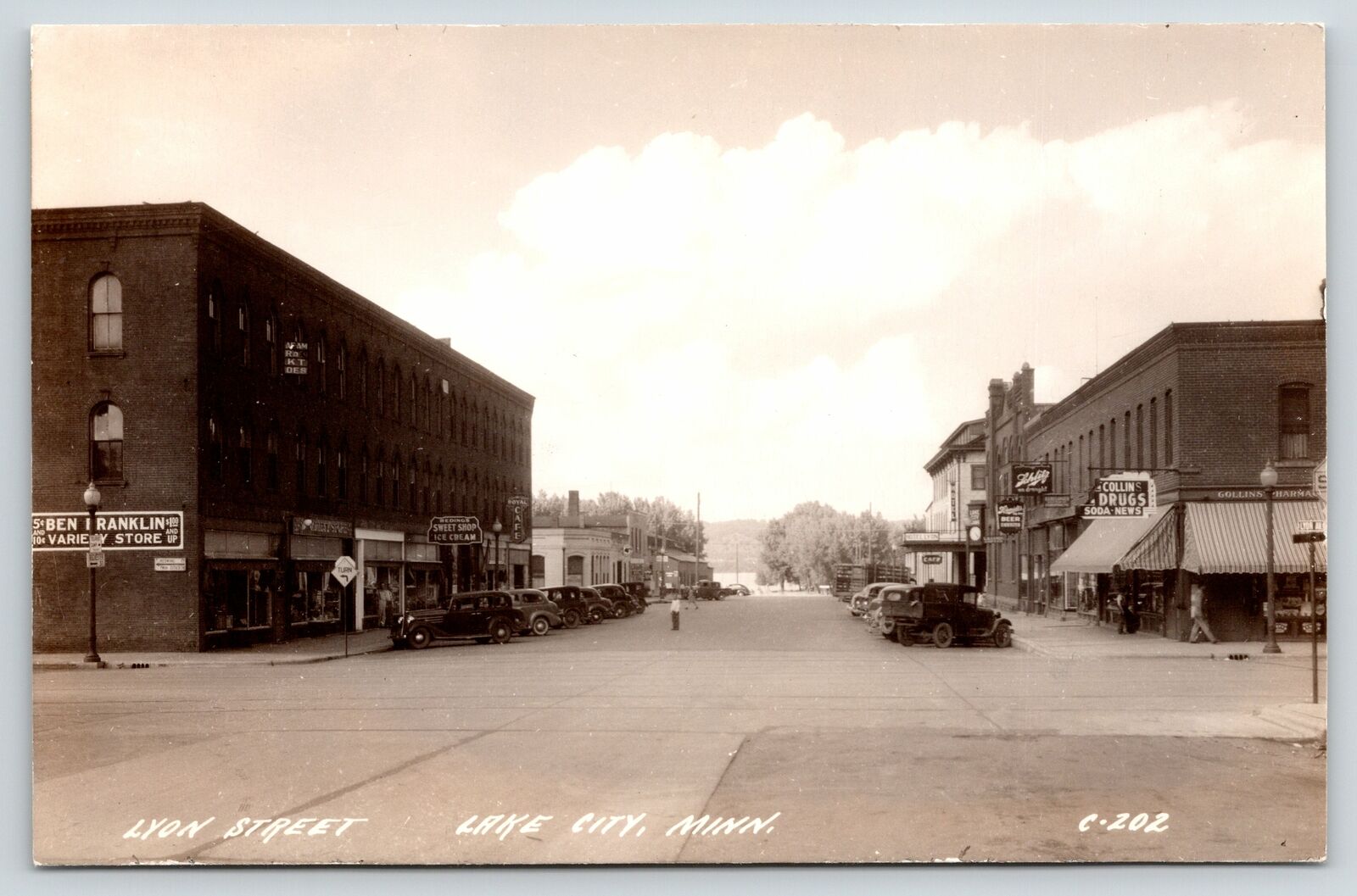 Lake City MN~Lyon Street~Ben Franklin Store~Sweet Shop Ice Cream~1940s Cars RPPC