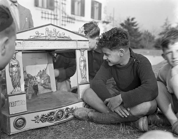 Boys Sit Crosslegged On The Grass As They Wait To Watch A Pu - 1950 Venice photo