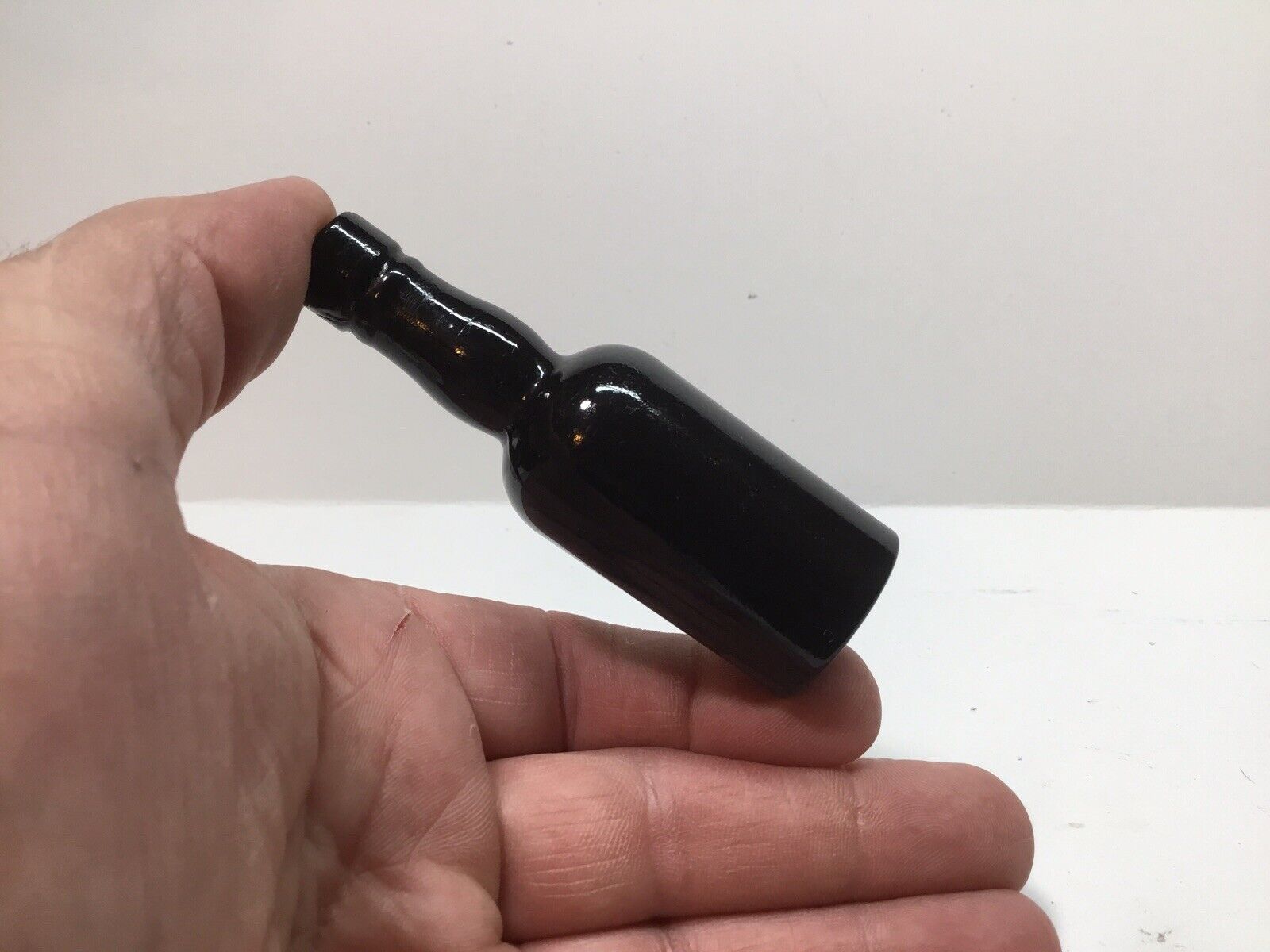 Tiny Antique Black Glass Sample Liquor Bottle.