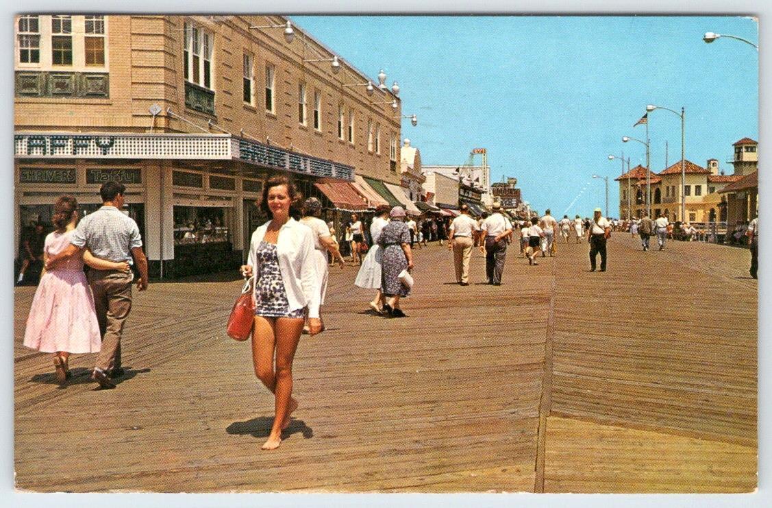 1961 OCEAN CITY NJ WOMAN IN VINTAGE SWIMSUIT STROLLLING THE BOARDWALK POSTCARD