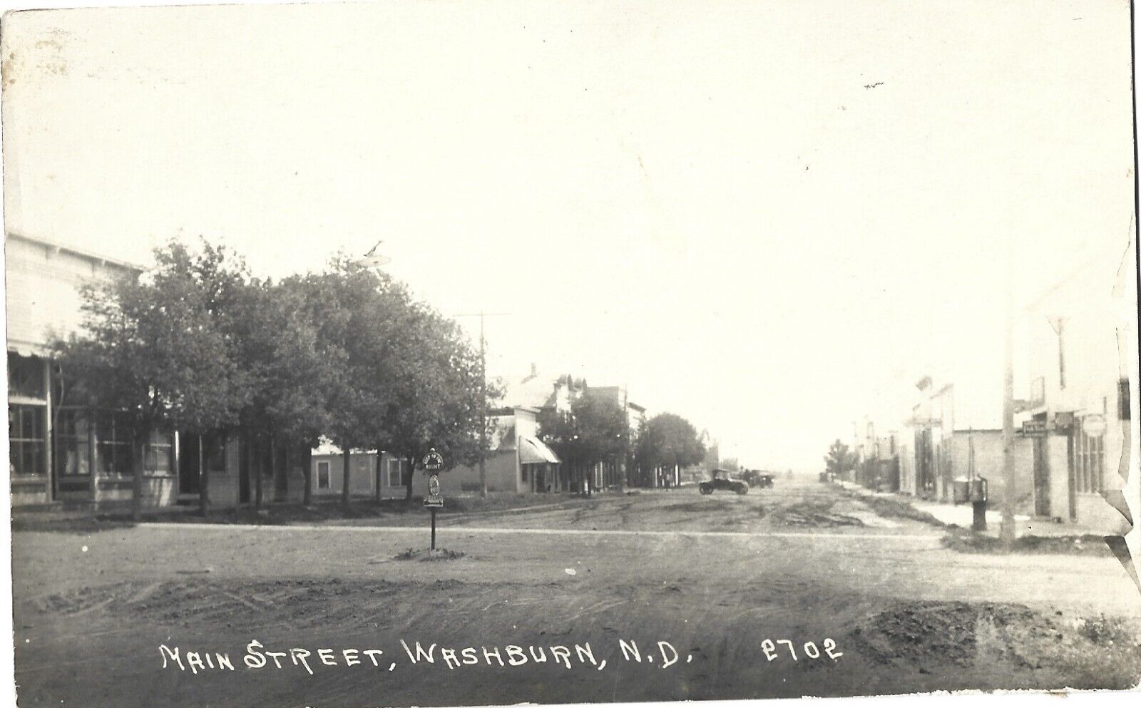 Washburn ND -- Main Street, store fronts, Model T\'s; nice 1928 RPPC