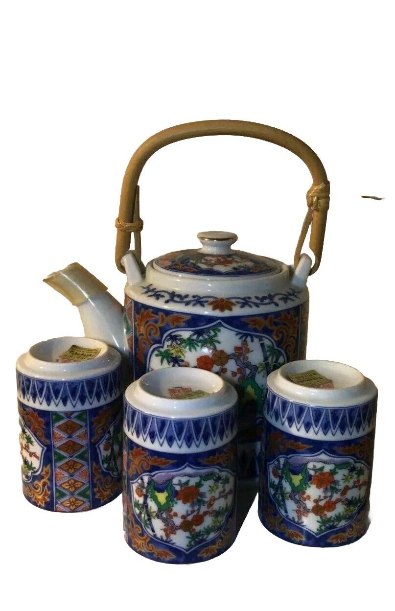 Antique porcelain set with three glasses and its jug decorated with flowers...