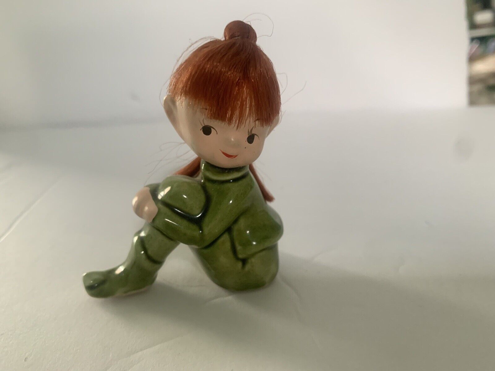 Red Haired Pixie In Green Suit Chip On Foot