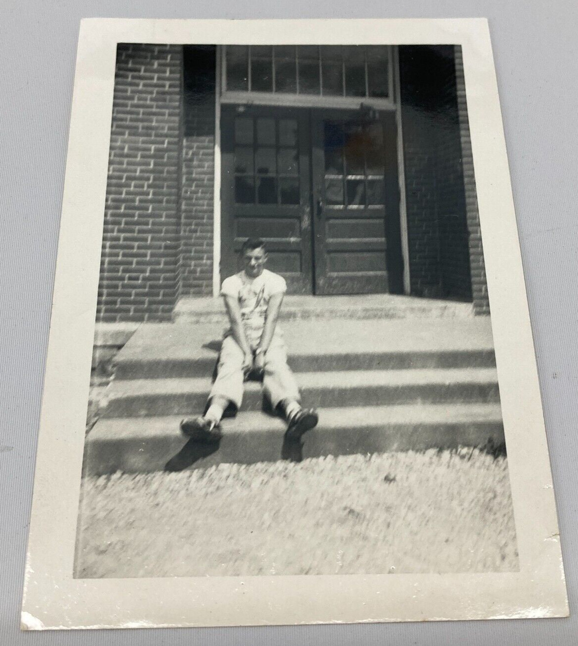 Found B&W Vintage Photo 1950-60\'s Man Sitting on Steps in Front of Doors