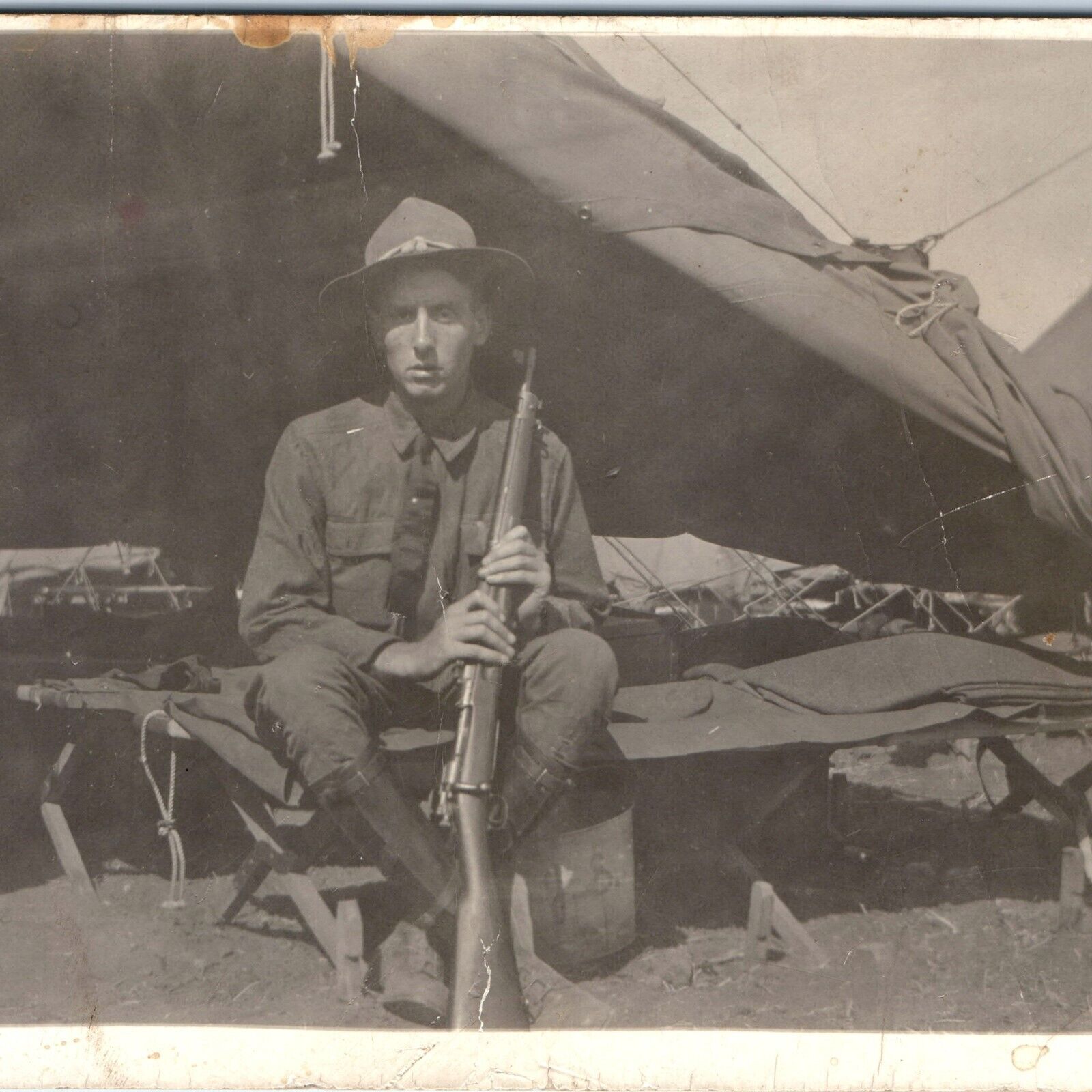 c1910s WWI Young USMC / Army Soldier Gun RPPC Barracks Cot Rifle Fort Photo A154