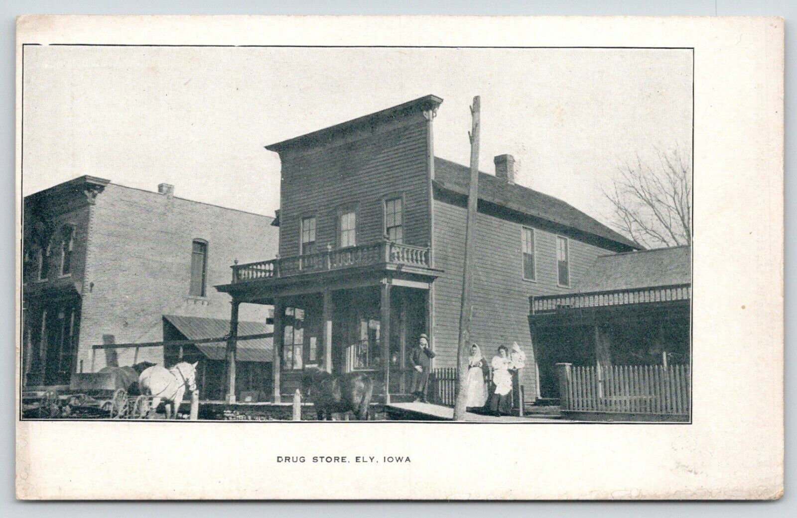 Ely IA~Balcony on Drug Store~Western Facade ~Baby on Fence~Hitching Posts c1910