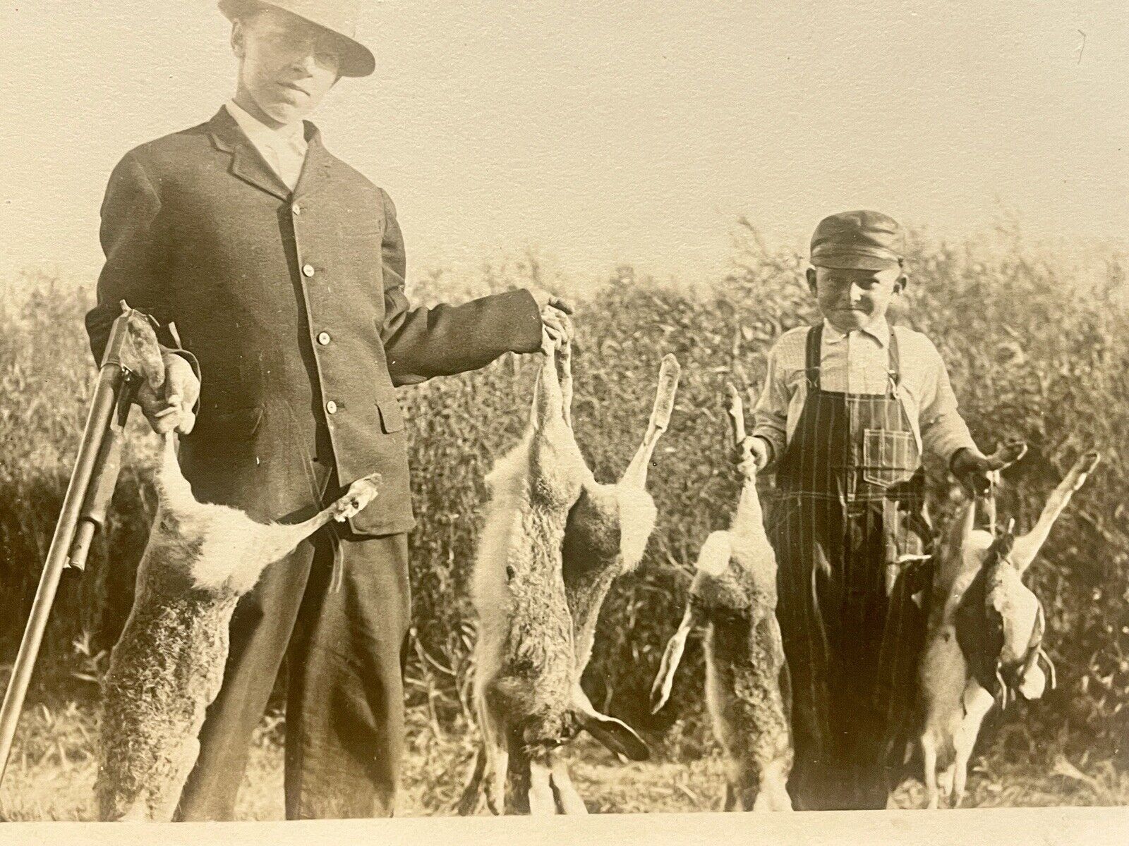 C1910 RPPC Hunting Posting  Man&Boy W Shotgun Huge Rabbits + Duck VELOX Postcard