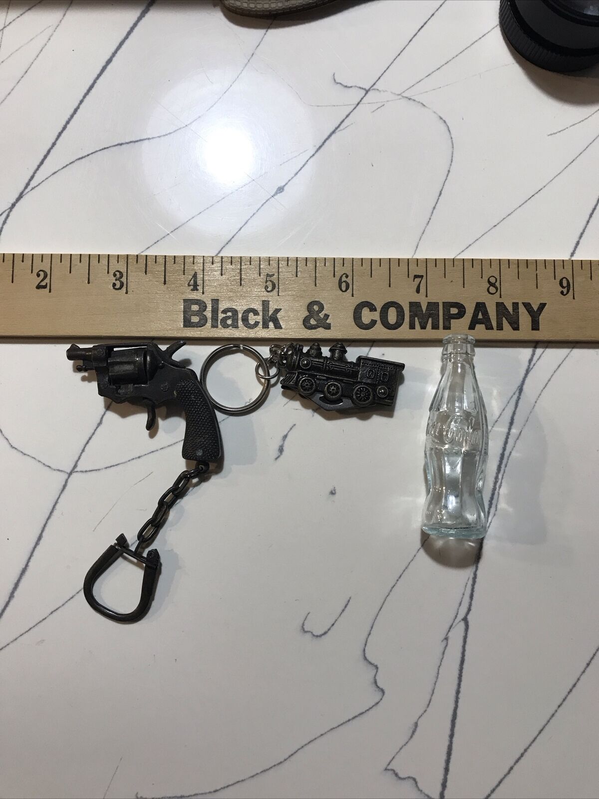 Miniature Trinkets Train, Coke Bottle, And Revolver