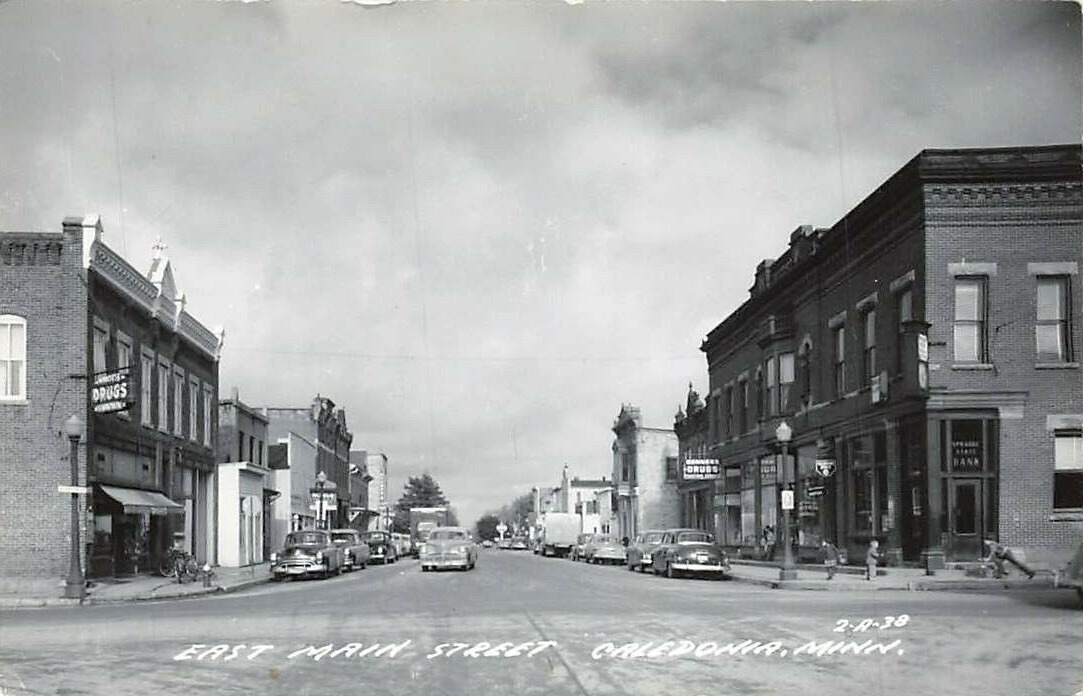 c1938 RPPC East Main Street Cars Stores Signs Caledonia MN Real Photo P381