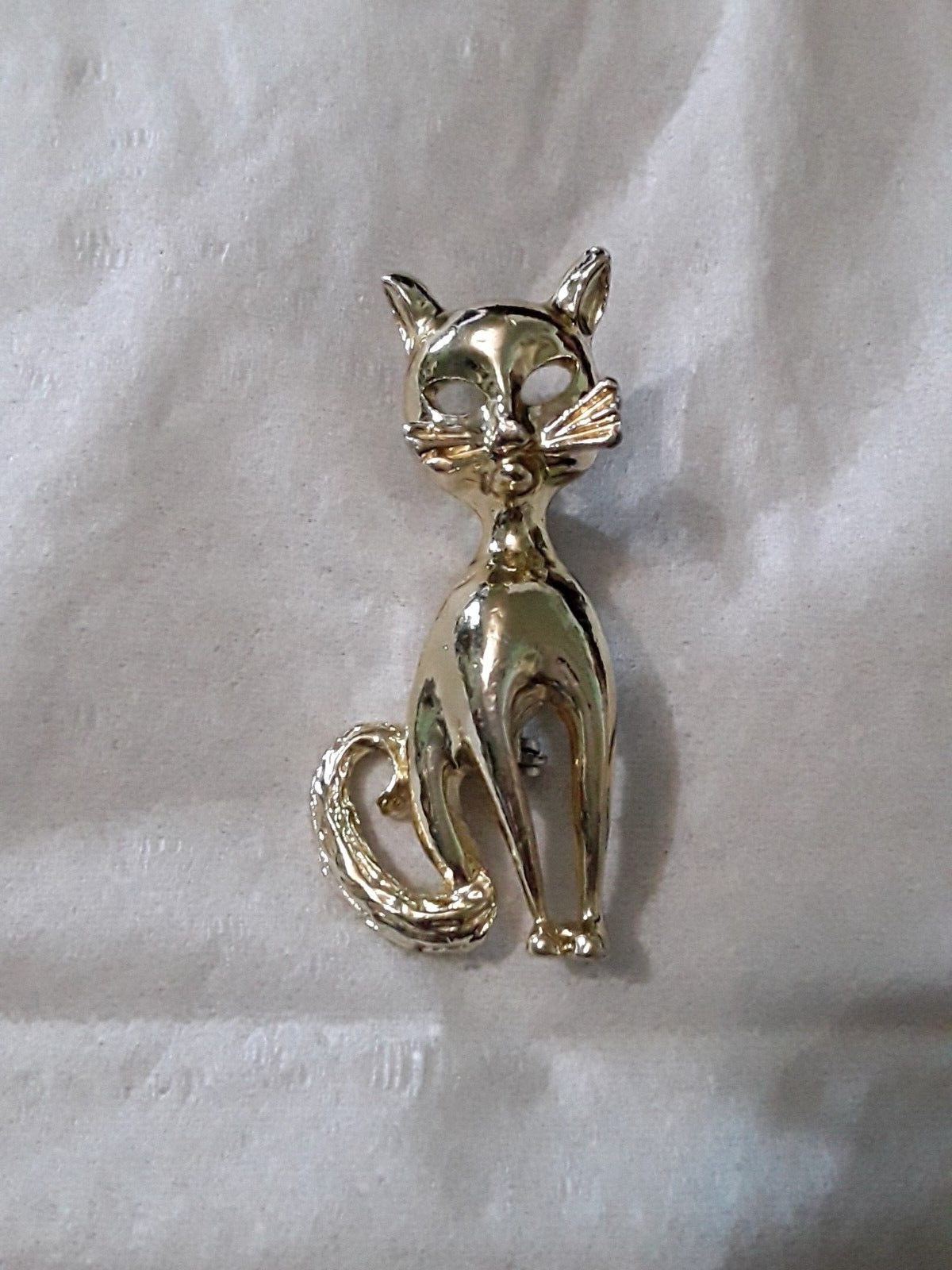 Cat pin with cut out eyes