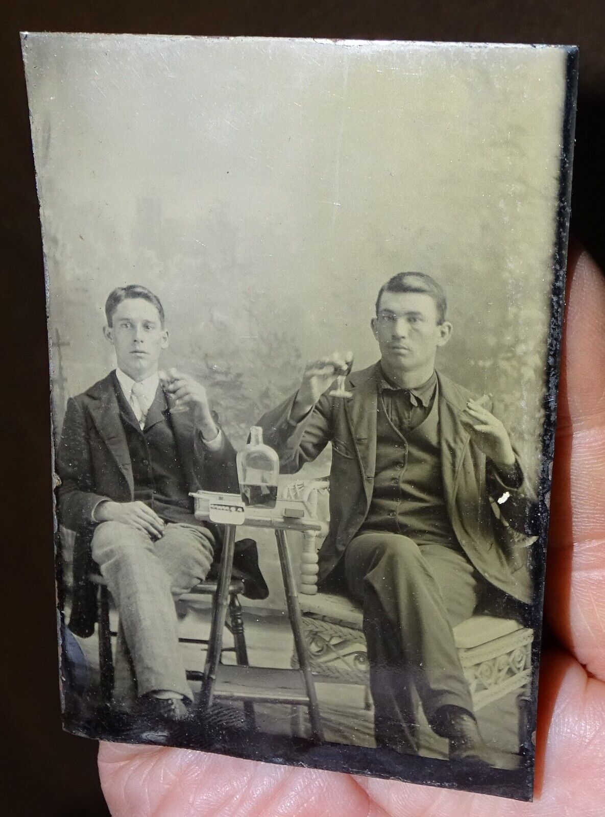 Tintype Photograph of 2 gents with whiskey and cigarettes, circa 1860s or 1870s