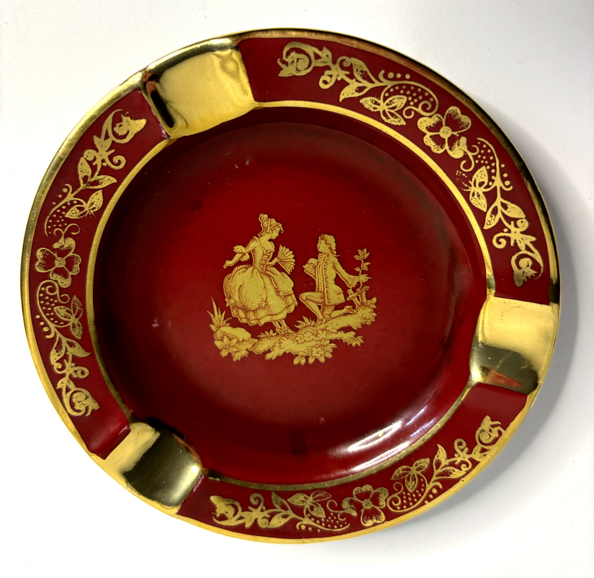 Vintage Limoges France porcelain ashtray in maroon with gold edges and accents,