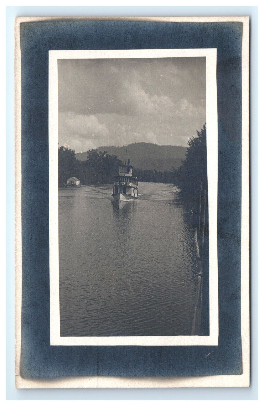 Postcard RPPC Boat on River Scenic View House and Hill in Background UNP