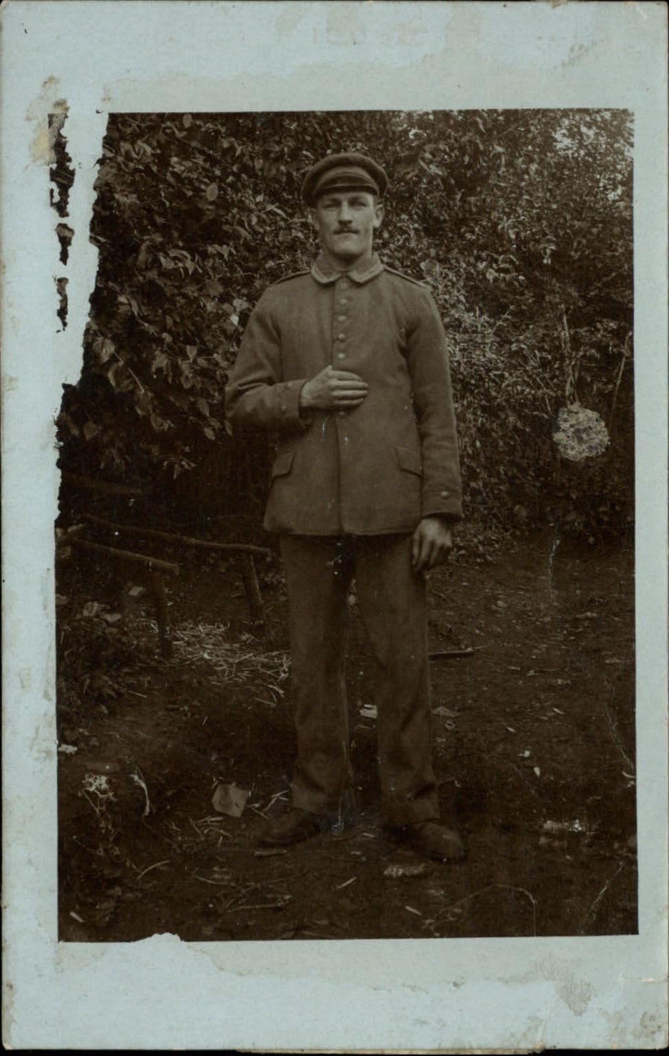 WWI RPPC German soldier standing outside Real Photo postcard message on back