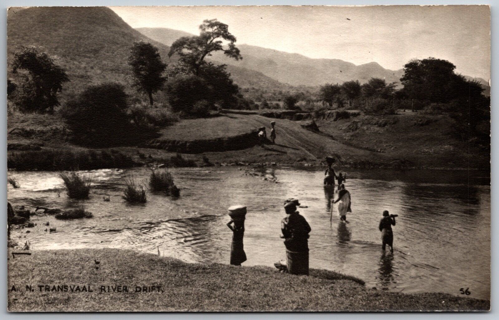 transvaal river drift south africa people carrying goods across water postcard