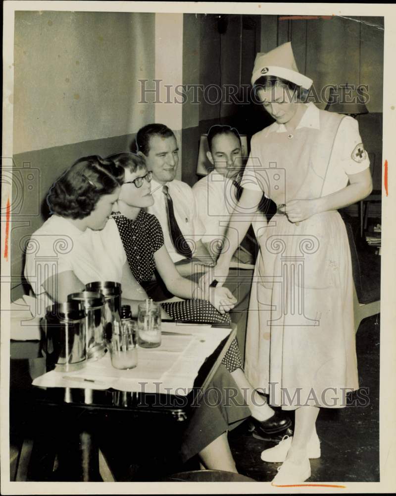1951 Press Photo Red Cross aide Joan Karnosh checks heart rate of Joyce Goodwill