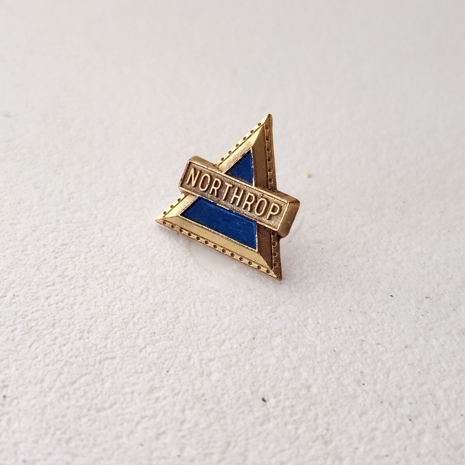 Vintage Northrop blue gold lapel pin