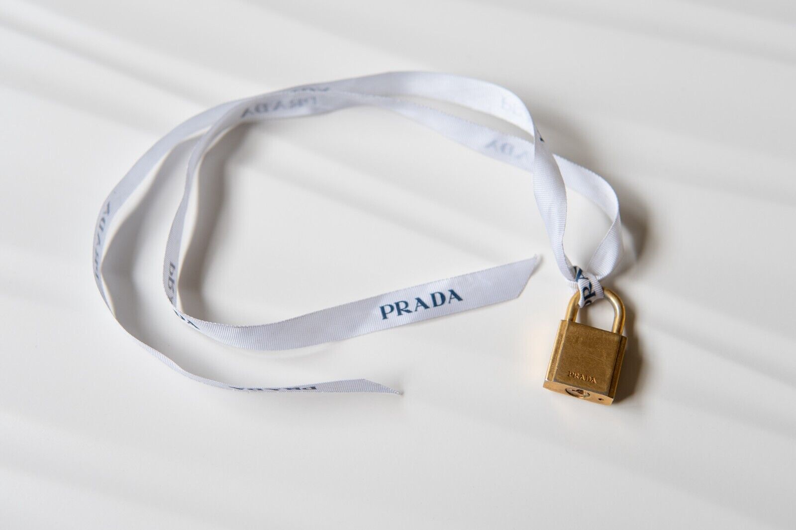 PRADA Gold Padlock Bag Charm with Ribbon & Pink Silk Pouch