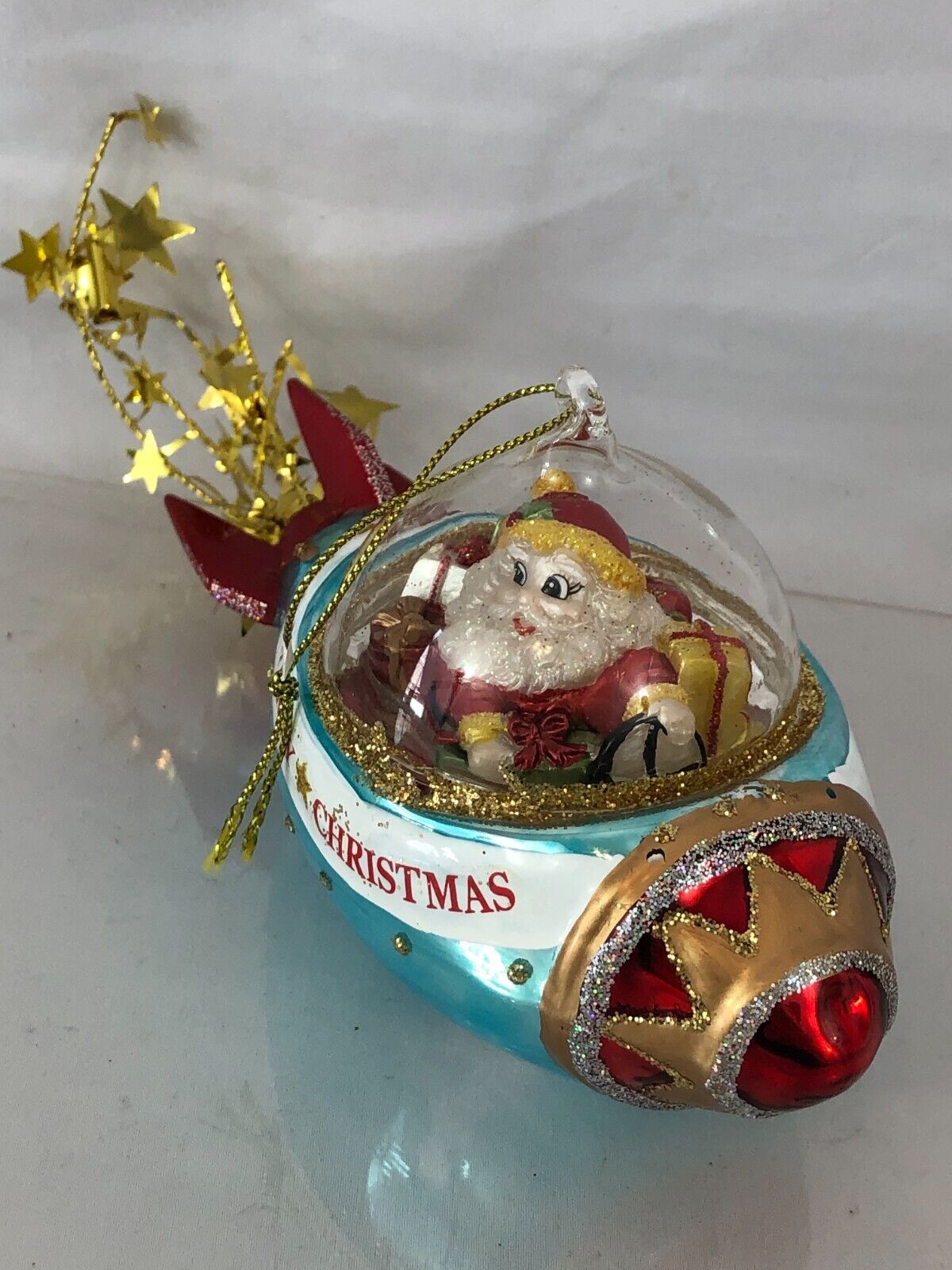 Stellar Voyage: Cosmic Santa Riding Spaceship Blown Glass Christmas Ornament