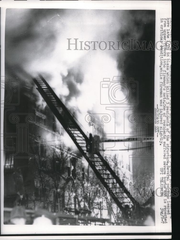 1959 Press Photo Fire Three residents killed and several jumped into firefighter