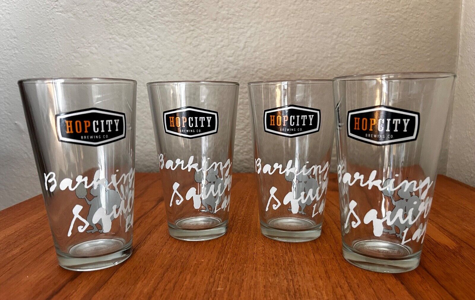 4 HOP CITY BREWING CO. PINT GLASSES - BARKING SQUIRREL LAGER