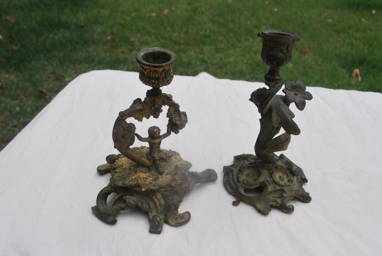 SMALL PAIR OF VINTAGE/ANTIQUE BRASS MISMATCHED CANDLE HOLDERS