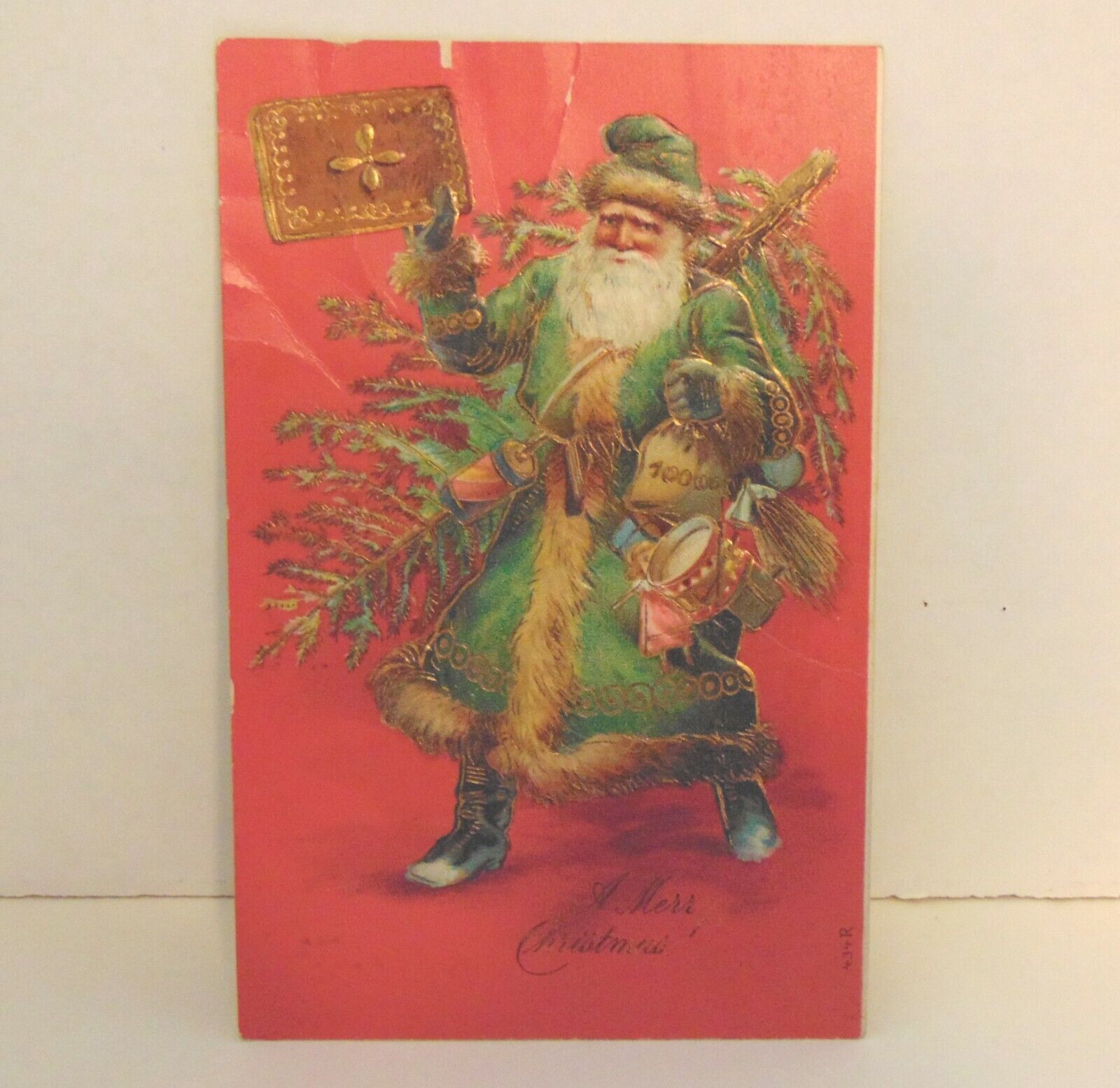 Pc-Antique.  1909. Santa- tree-drum- book-. Posted.  Emb. Some folds.   