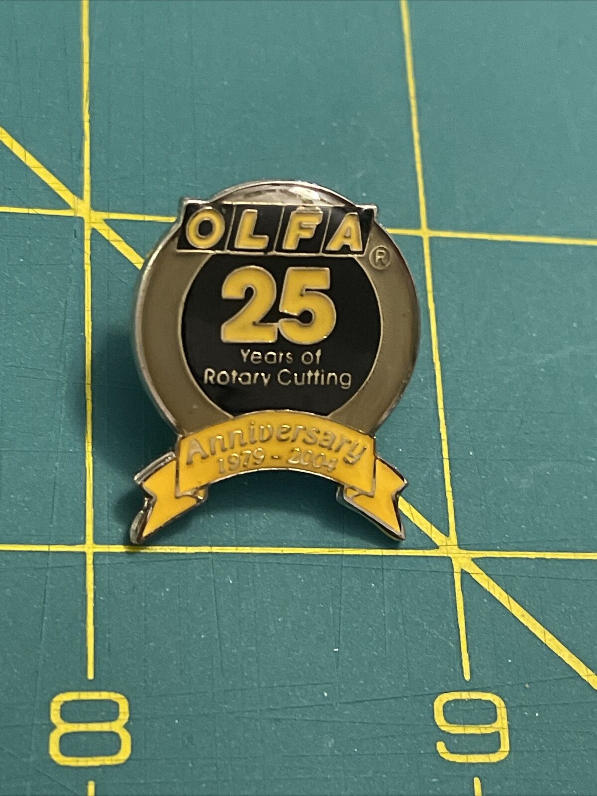 OLFA 25 Years Of Rotary Cutting Anniversary 1979-2004 Lapel Hat Pin Pinback
