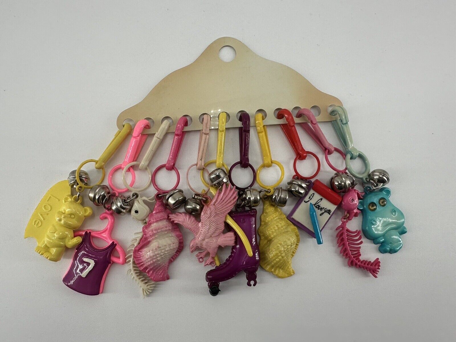 VTG CARDED 1980’s BELL CLIP CHARMS FOR NECKLACES 11 PLASTIC TOY NECKLACE CHARMS