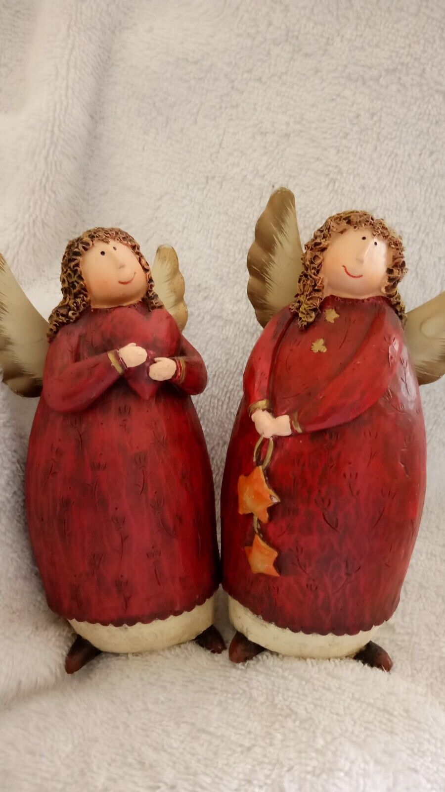 Pair of resin christmas angels with hearts and stars