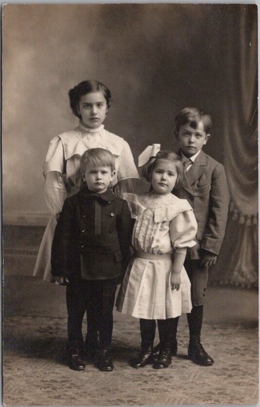 1910s RPPC Studio Photo Postcard Four Children / Siblings in Sunday Clothes