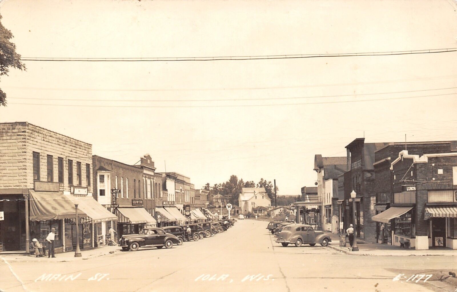 Iola Wisconsin~Main Street~Blatz Beer~Ford Car Dealer~Texaco~Meat~1940s RPPC